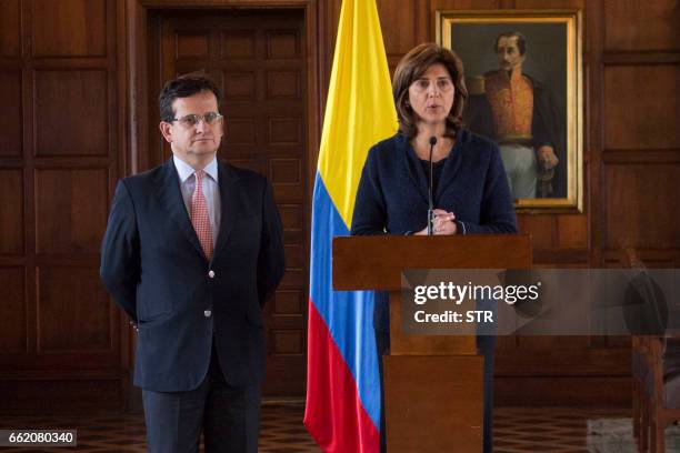 Colombian Foreign Minister Maria Angela Holguin and Colombia's ambassador to Venezuela, Ricardo Lozano, talk during a press conference in Bogota on...