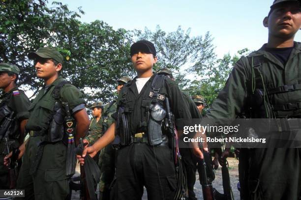 Soldiers break after a training exercise at FARC headquarters in Los Pozos, Colombia, August 25, 2000. The FARC maintains a force of 15,000 soldiers,...