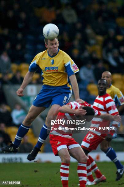 Mansfield Town's Jon Olav Hjelde and Doncaster Rovers' Lewis Guy in action