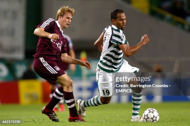 Sporting Lisbon's Alecsandro takes on and Bayern Munich's Andreas Ottl