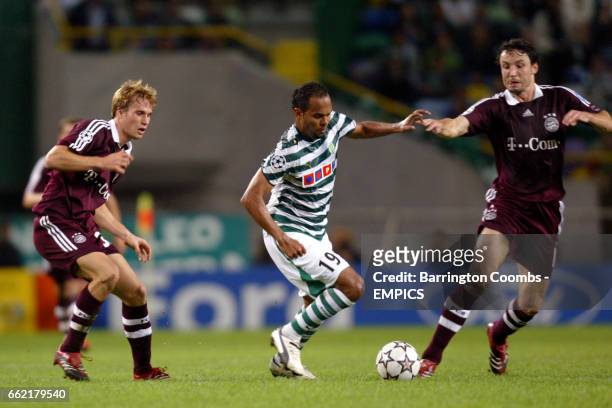 Sporting Lisbon's Alecsandro takes on and Bayern Munich's Andreas Ottl and Mark van Bommel
