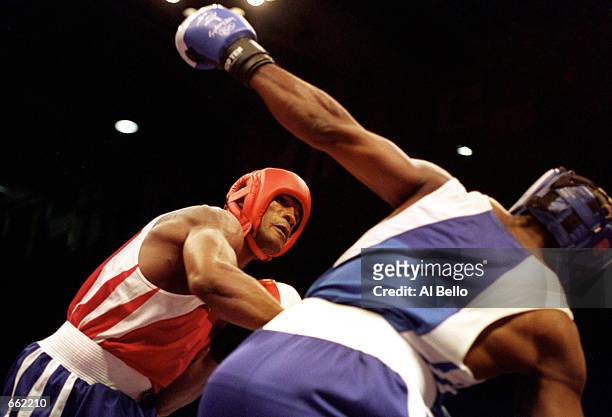 Felix Savon of Cuba, left, battles with American Michael Bennett in a 91 kilogram boxing bout September 26, 2000 during the 2000 Sydney Olympics in...
