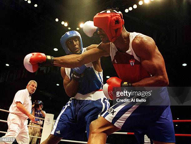 Felix Savon of Cuba, right, battles with American Michael Bennett during a 91 kilogram boxing bout September 26, 2000 during the 2000 Sydney Olympics...