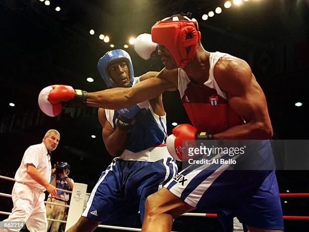 Felix Savon of Cuba, right, battles with American Michael Bennett during a 91 kilogram boxing bout September 26, 2000 during the 2000 Sydney Olympics...