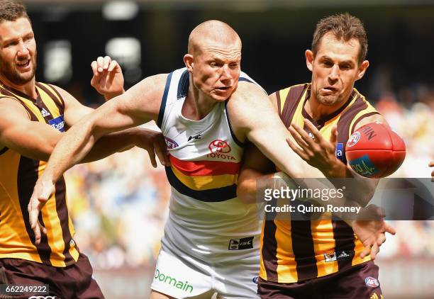 Sam Jacobs of the Crows is bumped by Luke Hodge of the Hawks during the round two AFL match between the Hawthorn Hawks and the Adelaide Crows at...
