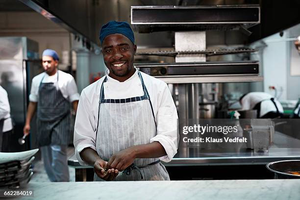 portrait of chef smiling inside kicthen - black apron stock pictures, royalty-free photos & images