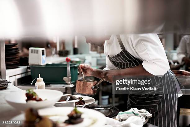chef finishing dishes at restaurant - catering building stock pictures, royalty-free photos & images