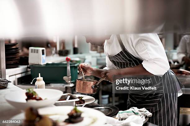chef finishing dishes at restaurant - saucepan - fotografias e filmes do acervo