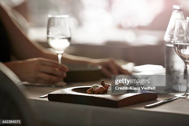 fresh dish at restaurant with guest in back - differential focus stock pictures, royalty-free photos & images