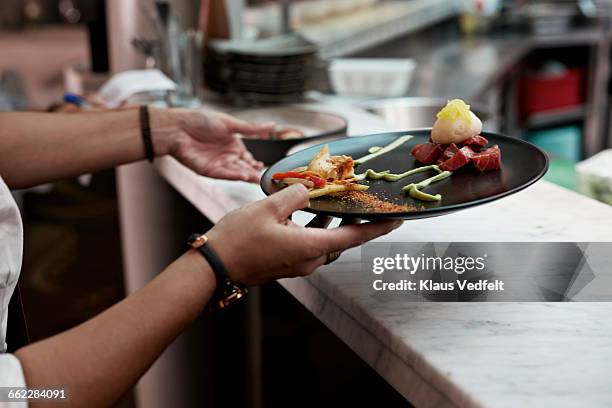 close-up of waiter picking up dishes for serving - kellnerin stock-fotos und bilder