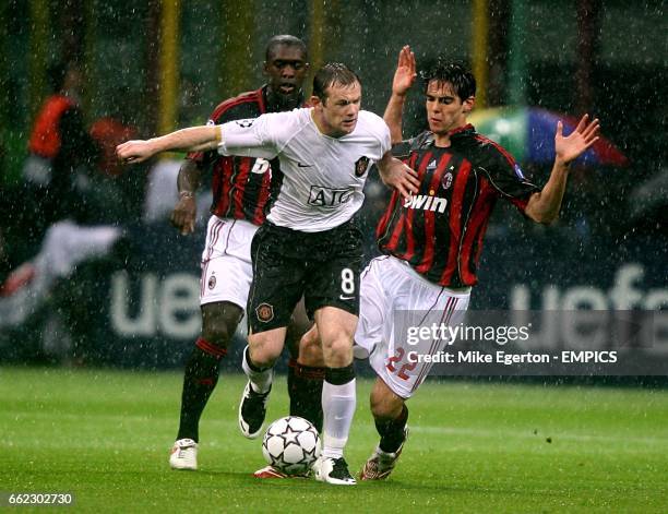Milan's Clarence Seedorf and Kaka combine to tackle Manchester United's Wayne Rooney