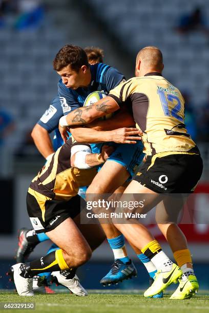 Matt Duffie of the Blues is tackled during the round six Super Rugby match between the Blues and the Force at Eden Park on April 1, 2017 in Auckland,...