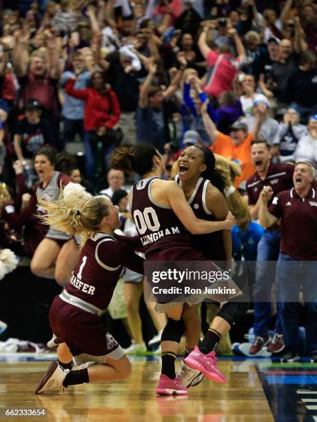 Morgan William of the Mississippi State Lady Bulldogs celebrates with teammates after making the game-winning shot to defeat the Connecticut Huskies...