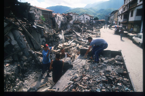 residents-attempt-to-salvage-materials-august-16-1999-from-a-bombed-house-in-pec-kosovo.jpg