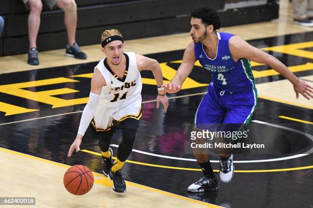 Maura of the UMBC Retrievers dribble sup court past Ehab Amin of the Texas A&M-CC Islanders during the Semi-final of the CollegeInsider.com...