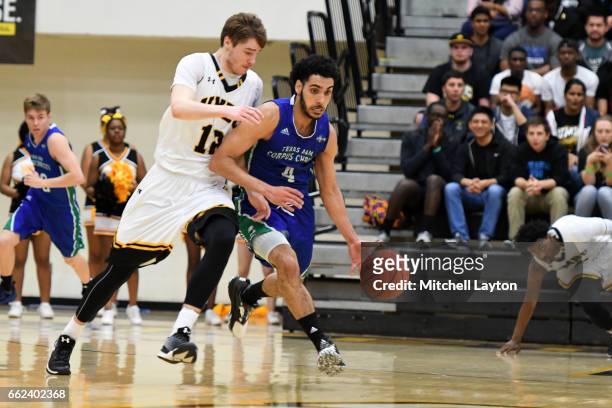 Ehab Amin of the Texas A&M-CC Islanders dribbles the ball the ball by Will Darley of the UMBC Retrievers during the Semi-final of the...