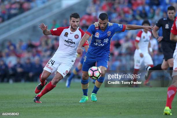Andrew Nabbout of the Jets contests the ball with Terry Antonis of the Wanderers during the round 25 A-League match between the Newcastle Jets and...