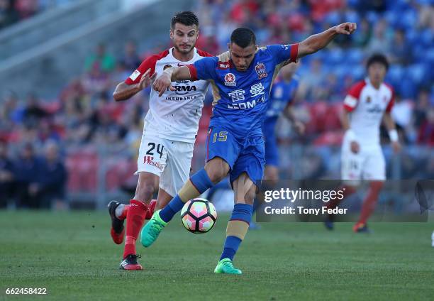 Andrew Nabbout of the Jets contests the ball with Terry Antonis of the Wanderers during the round 25 A-League match between the Newcastle Jets and...