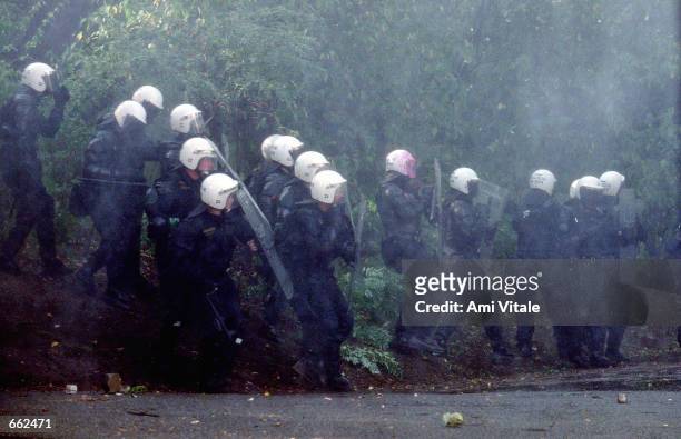Czech police shield themselves during a street battle with anti-globalization demonstrators September 26, 2000 in Prague, Czech Republic. The...
