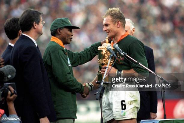 South Africa captain Francois Pienaar receives the William Webb Ellis Trophy from Nelson Mandela