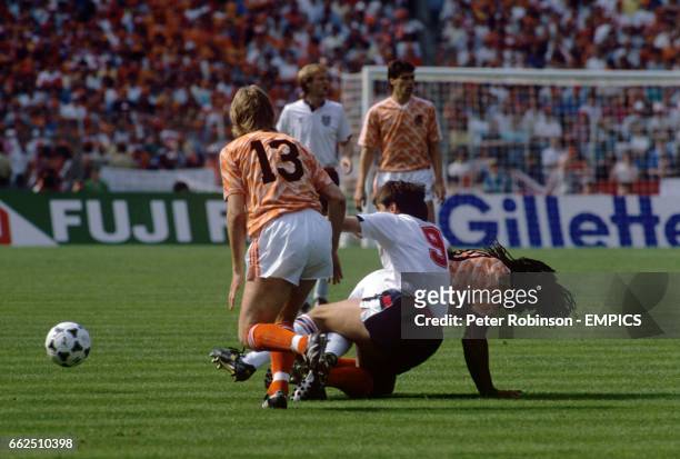 England's Peter Beardsley is tackled by Holland's Erwin Koeman and Ruud Gullit