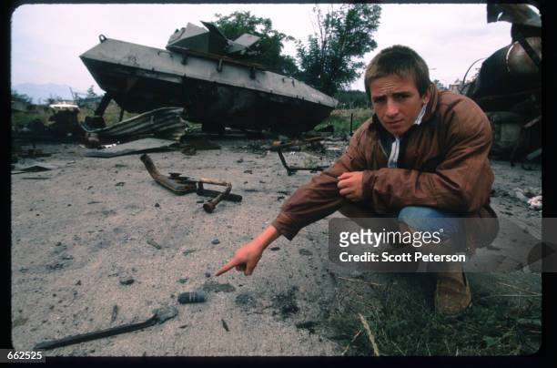 Kosovar Bardhyl Kamberi August 28,1999 points to a spent bullet casing from 30-mm depleted uranium rounds, used by American aircraft in Djakovica,...