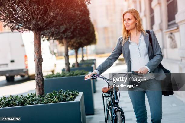 pregnant businesswoman riding bicycle - laptop bag stock pictures, royalty-free photos & images