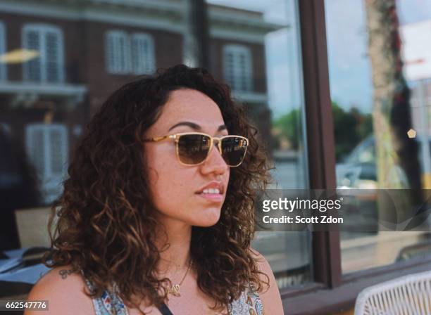 close-up of woman sitting outside cafe - scott zdon stock pictures, royalty-free photos & images