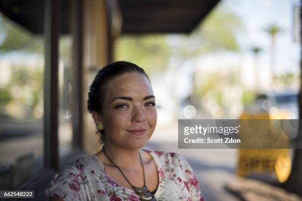 close-up of woman sitting outside cafe - scott zdon stock pictures, royalty-free photos & images
