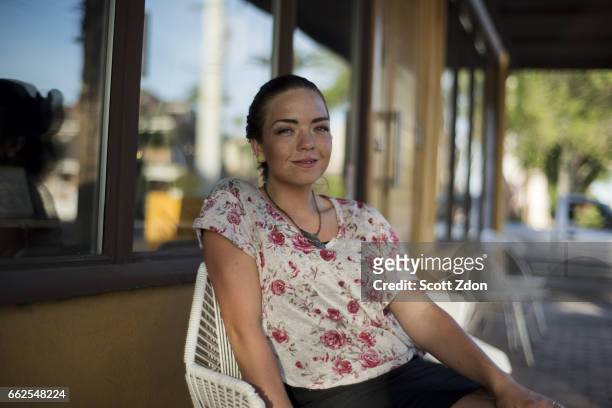 woman sitting outside cafe - scott zdon stock-fotos und bilder