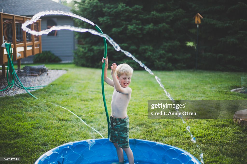 Happy Boy With Garden Hose