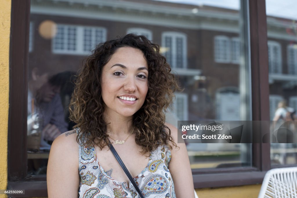 Close-up of woman sitting outside cafe