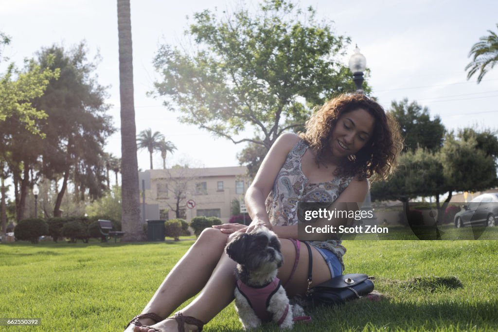 Woman sitting in park with dog