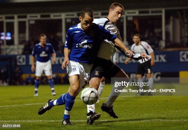 Everton's Leon Osman and Luton Town's Chris Perry battle for the ball.