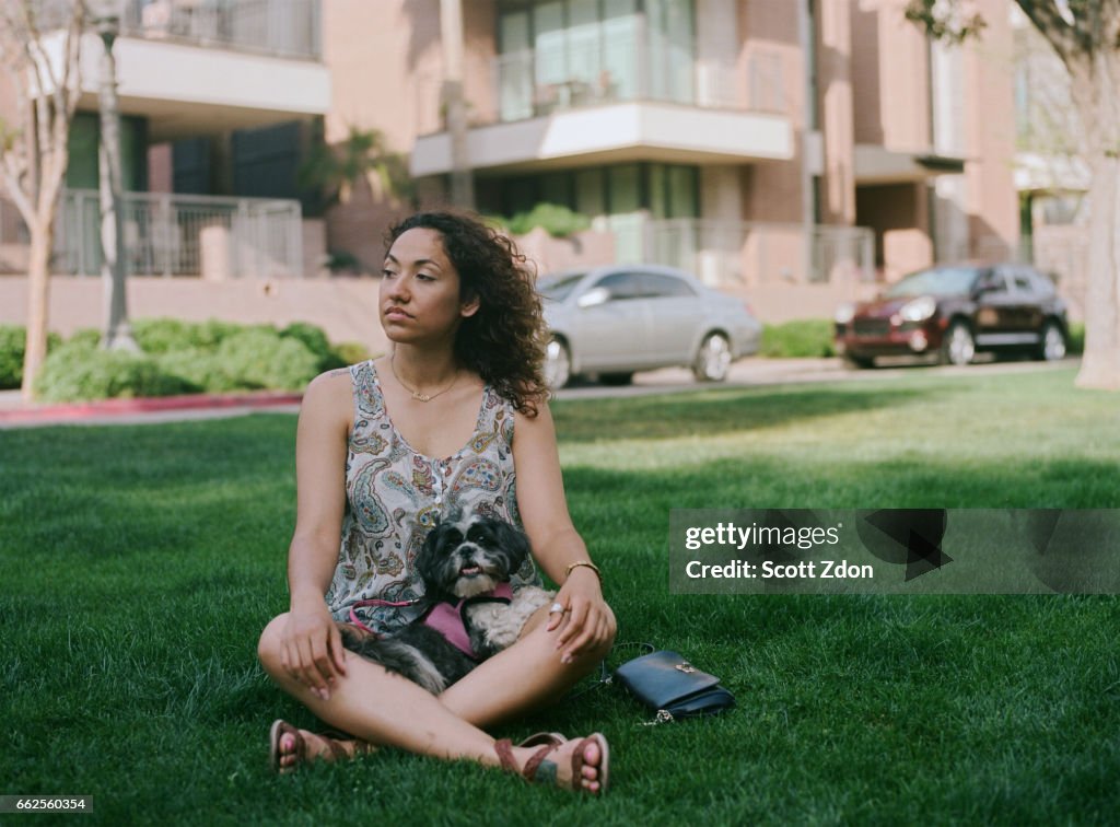 Woman sitting in park with dog