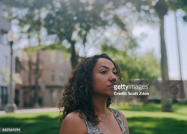 close-up of hispanic woman in park - scott zdon stock pictures, royalty-free photos & images