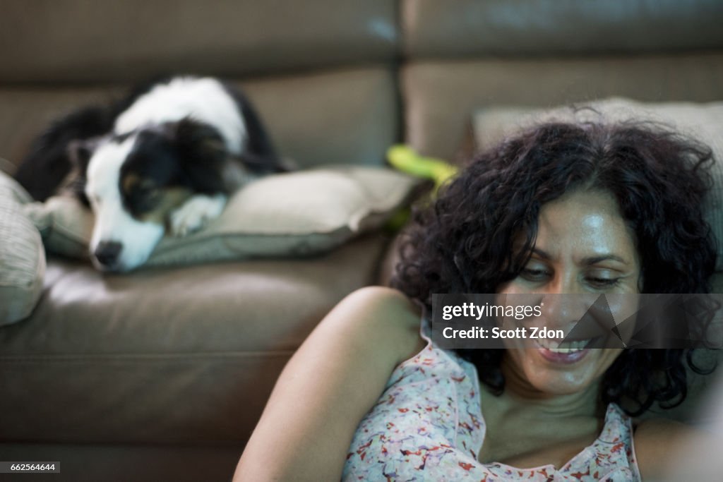 Woman smiling with Border Collie in background