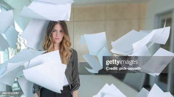 woman with paper all around her in conference room - buried paperwork stock pictures, royalty-free photos & images