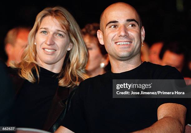 Tennis stars Andre Agassi and Steffi Graf attend the Oscar De La Hoya versus Felix Trinidad welterweight championship fight September 18, 1999 at the...