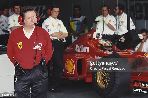 General Manager of the Ferrari Racing Division Jean Todt looks on as Michael Schumacher sits aboard the Scuderia Ferrari SpA Ferrari F310 Ferrari 046...