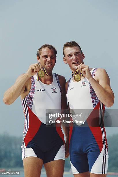 Steven Redgrave and Matthew Pinsent of Great Britain celebrate with their gold medals after winning the Men's Coxless Pairs rowing event during the...
