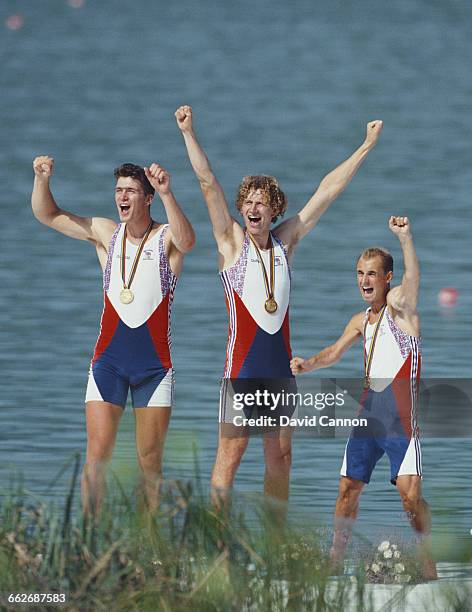 Brothers Greg and Jonny Searle and the cox Garry Herbert of Great Britain celebrate winning the Men's Coxed Pairs rowing event during the XXV Summer...