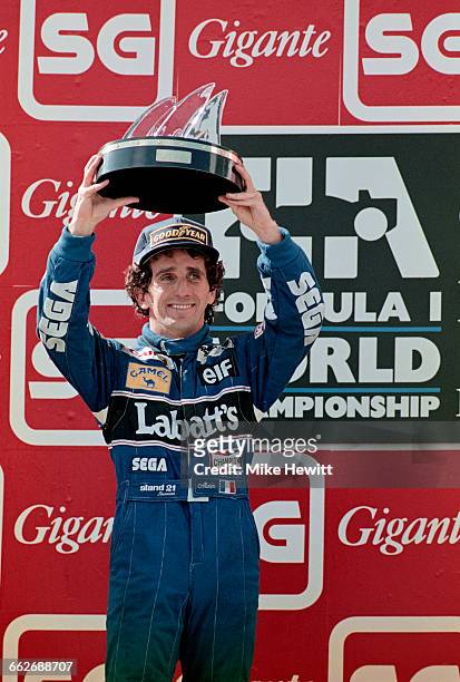 Alain Prost of France, driver of the Canon Williams Renault Williams FW15C Renault V10 celebrates his second place in the race and winning his fourth...