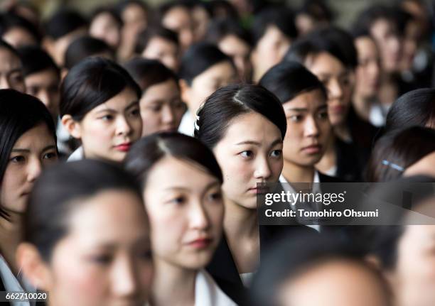 Newly hired employees attend the welcome ceremony of ANA Holdings Inc. At the company's hanger on April 1, 2017 in Tokyo, Japan. Japanese airlines...