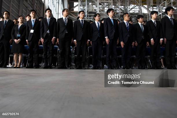 Newly hired employees attend the welcome ceremony of ANA Holdings Inc. At the company's hanger on April 1, 2017 in Tokyo, Japan. Japanese airlines...