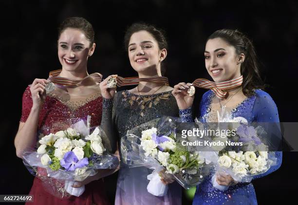 Russia's Evgenia Medvedeva attends an award ceremony after winning the women's gold medal at the International Skate Union's world championships in...