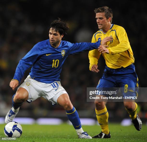 Brazil's Diego Ribas and Sweden's Anders Svensson battle for the ball.