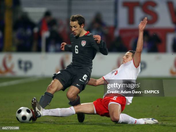 Poland's Dariusz Dudka tackles USA's Steve Cherundolo