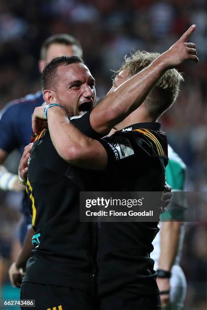 Aaron Cruden celebrates with Damian McKenzie after his try for the Chiefs during the round six Super Rugby match between the Chiefs and the Bulls at...