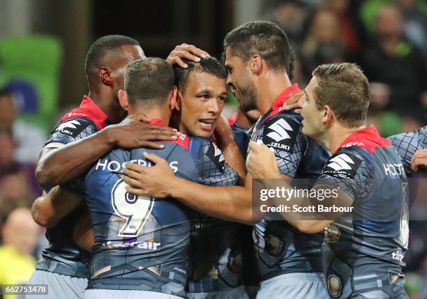 Will Chambers of the Melbourne Storm is congratulated by his teammates after scoring the second try of the match during the round five NRL match...